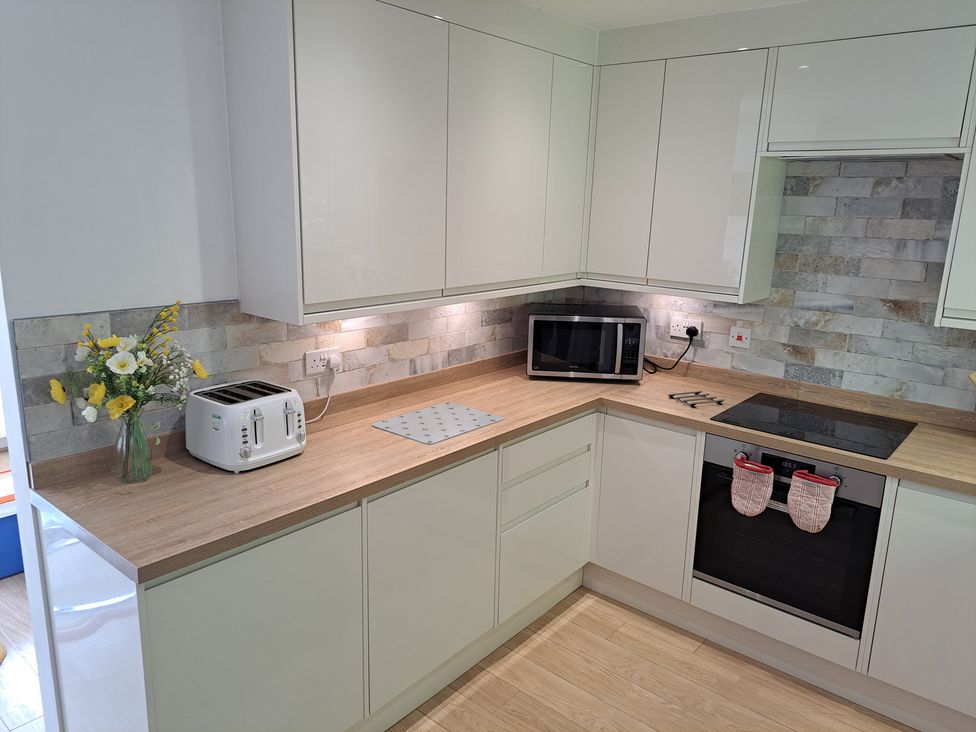 A kitchen with a toaster and microwave at Castle Cove View in Castle Cove