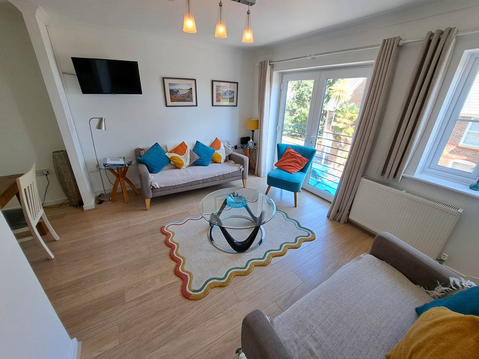 A living room with a coffee table and sofa at Castle Cove View in Castle Cove