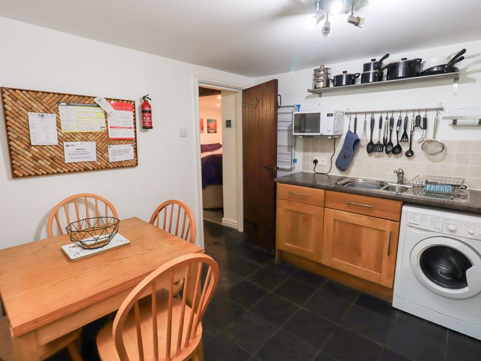 A kitchen with dining table and kitchen appliances at Kiln How Threlkeld