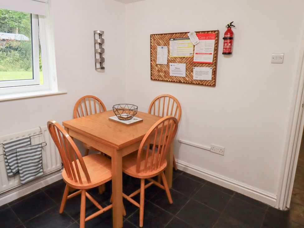 A dining room with a table and chairs at Kiln How in Threlkeld
