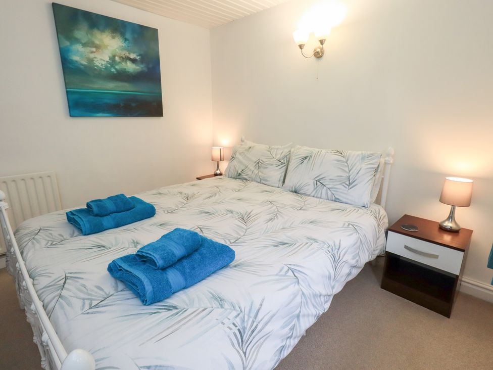 A bedroom with a bed and nightstand at Kiln How in Threlkeld