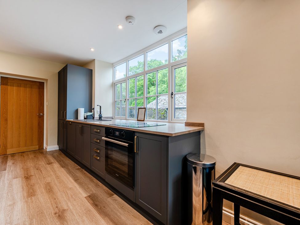 A kitchen with oven and sink at Home Farmhouse at the Graythwaite Estate near Hawkshead