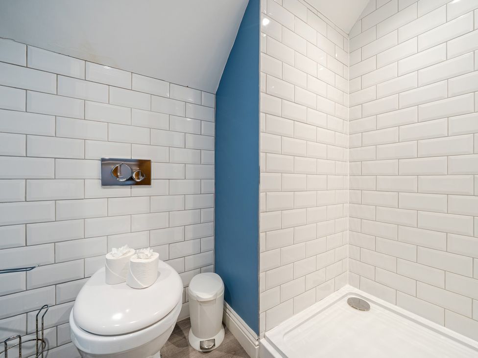 A bathroom with a toilet and shower at Home Farmhouse at the Graythwaite Estate near Hawkshead