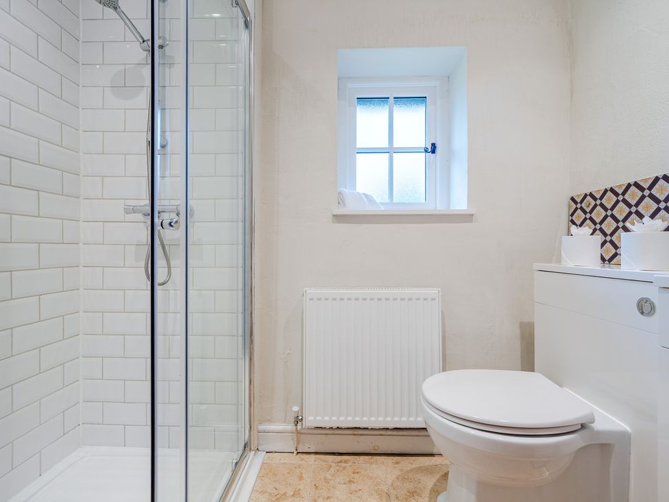 A bathroom with a shower and toilet at Home Farmhouse at the Graythwaite Estate near Hawkshead