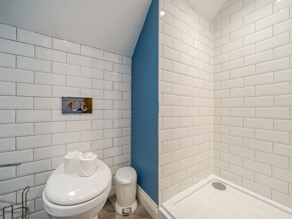 A bathroom with a toilet and shower at Home Farmhouse at the Graythwaite Estate near Hawkshead