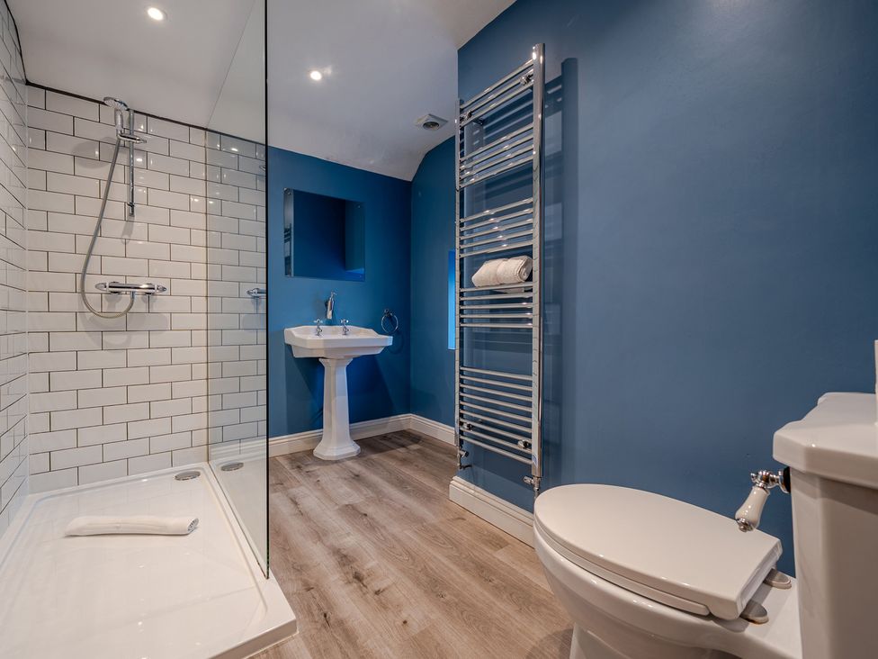A bathroom with shower, sink, and toilet at Home Farmhouse at the Graythwaite Estate near Hawkshead
