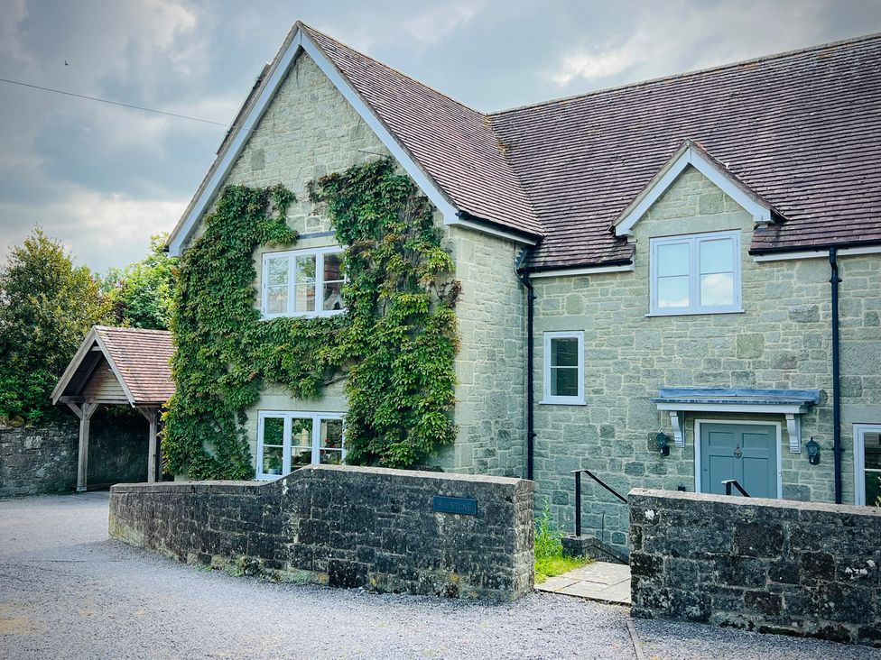 A house with stone walls and a driveway at Samstone Donhead St. Mary near Ludwell
