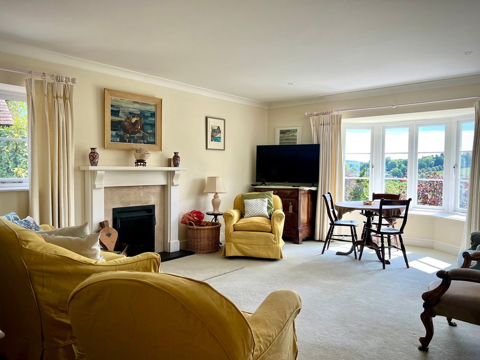 A living room with a television and a table at Samstone Donhead St. Mary near Ludwell