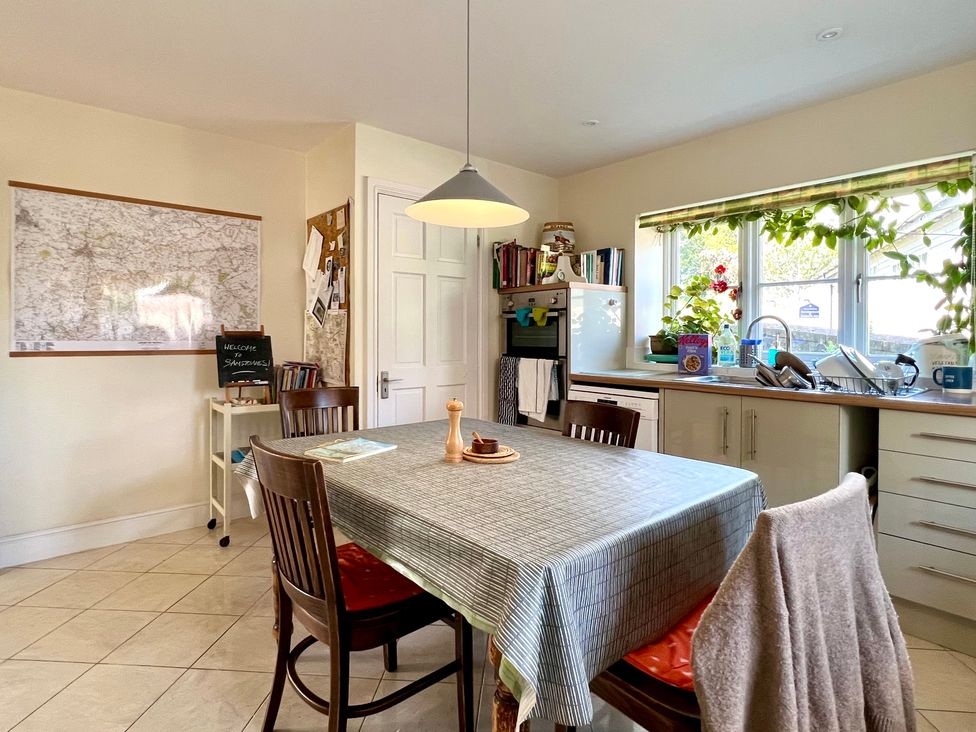 A kitchen with a table and chairs at Samstone in Donhead St. Mary near Ludwell