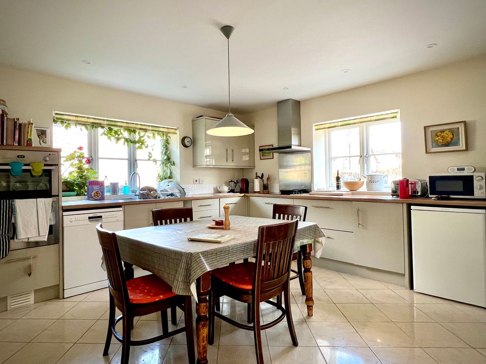 A kitchen with a table and chairs at Samstone in Donhead St. Mary near Ludwell