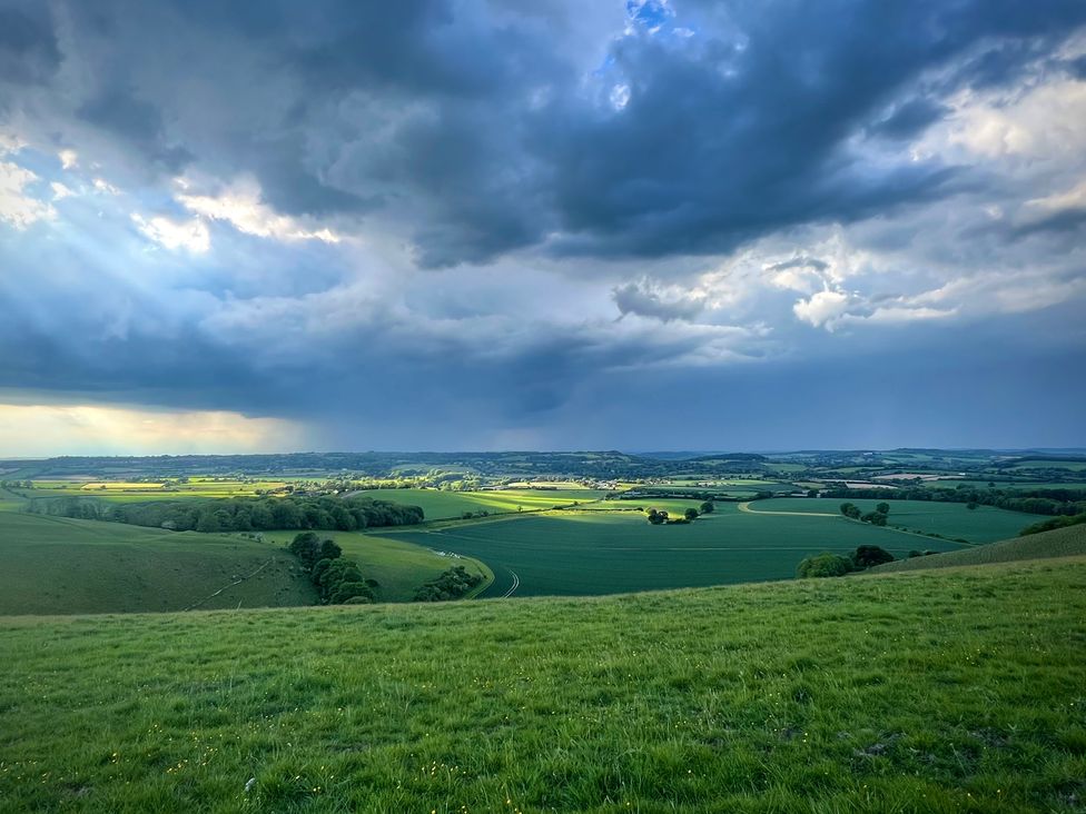 A panoramic view of fields and cloudy sky at Samstone in Donhead St. Mary near Ludwell