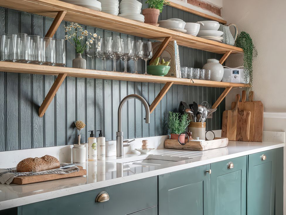 A kitchen with shelves containing glasses and utensils at Reybridge House in Lacock