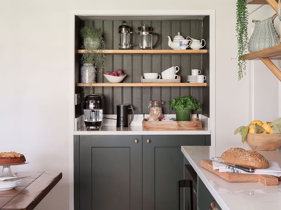 A kitchen with shelving units and various kitchen appliances at Reybridge House in Lacock