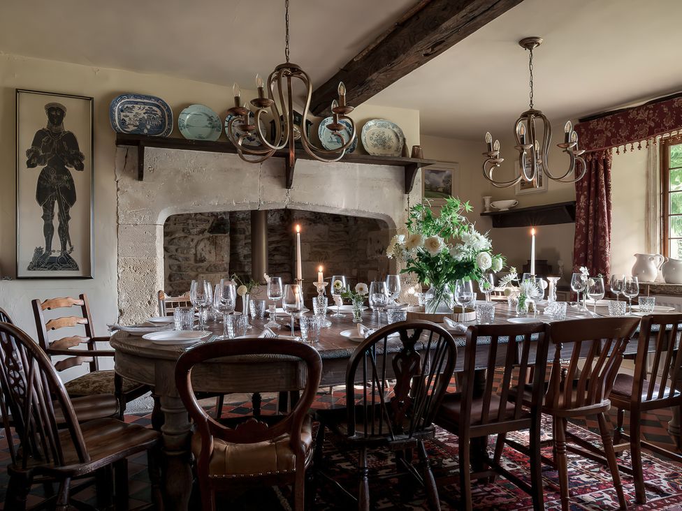 A dining room with a table set for dinner at Reybridge House in Lacock