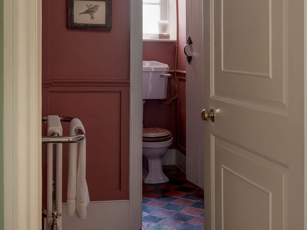 A bathroom with a toilet and towel rack at Reybridge House in Lacock