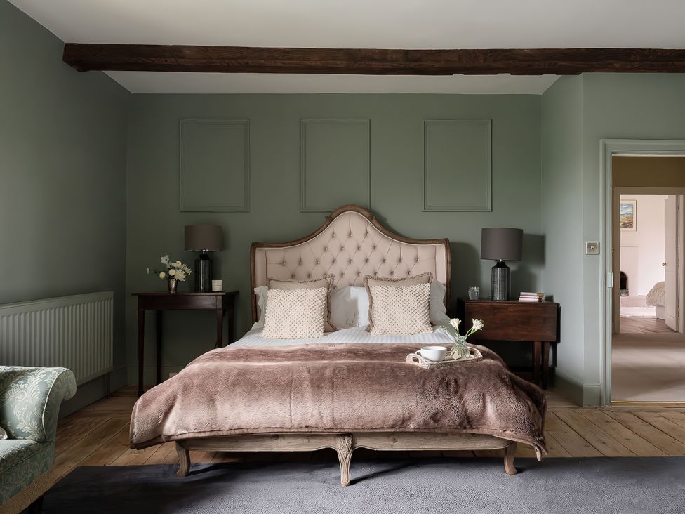 A bedroom with a bed and bedside tables at Reybridge House in Lacock