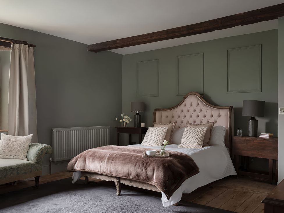 A bedroom with a bed and nightstand at Reybridge House in Lacock