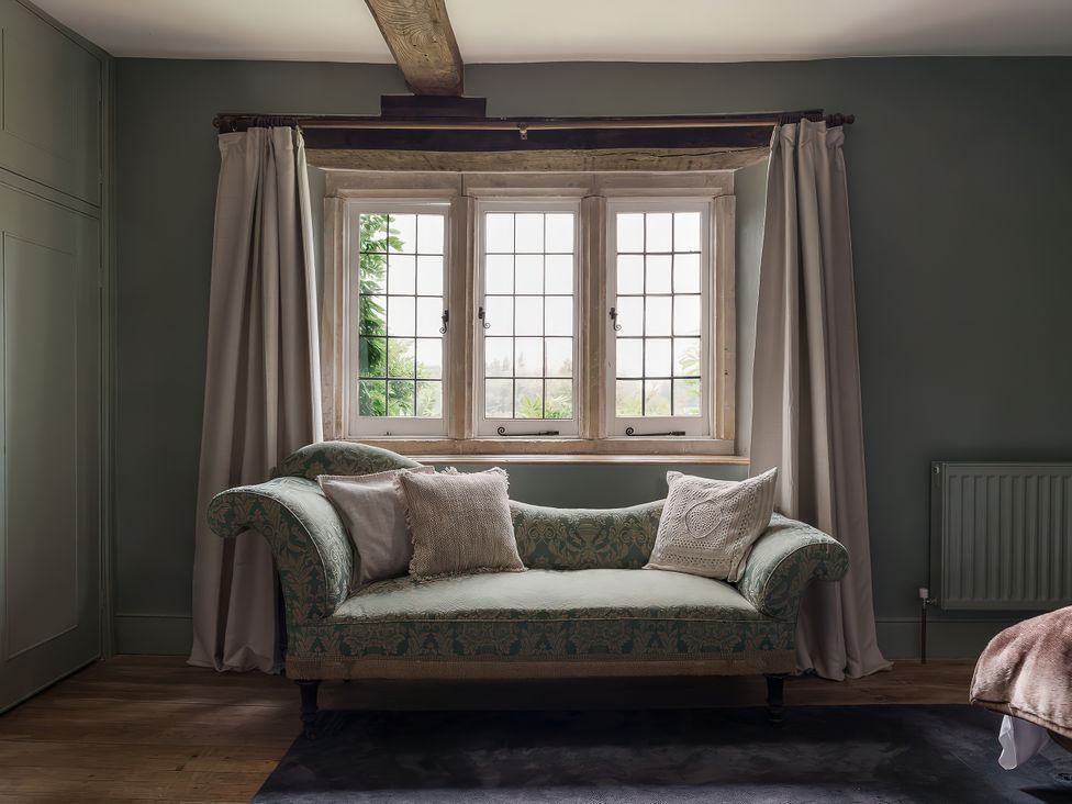 A living room with a sofa and window at Reybridge House in Lacock