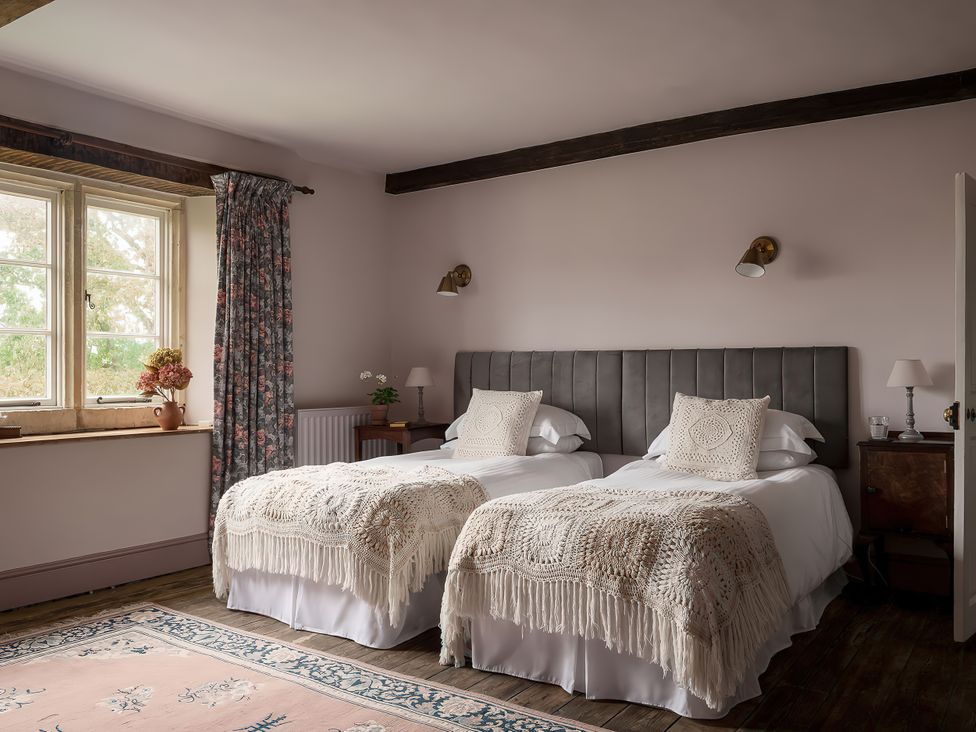 A bedroom with two beds and a window at Reybridge House in Lacock