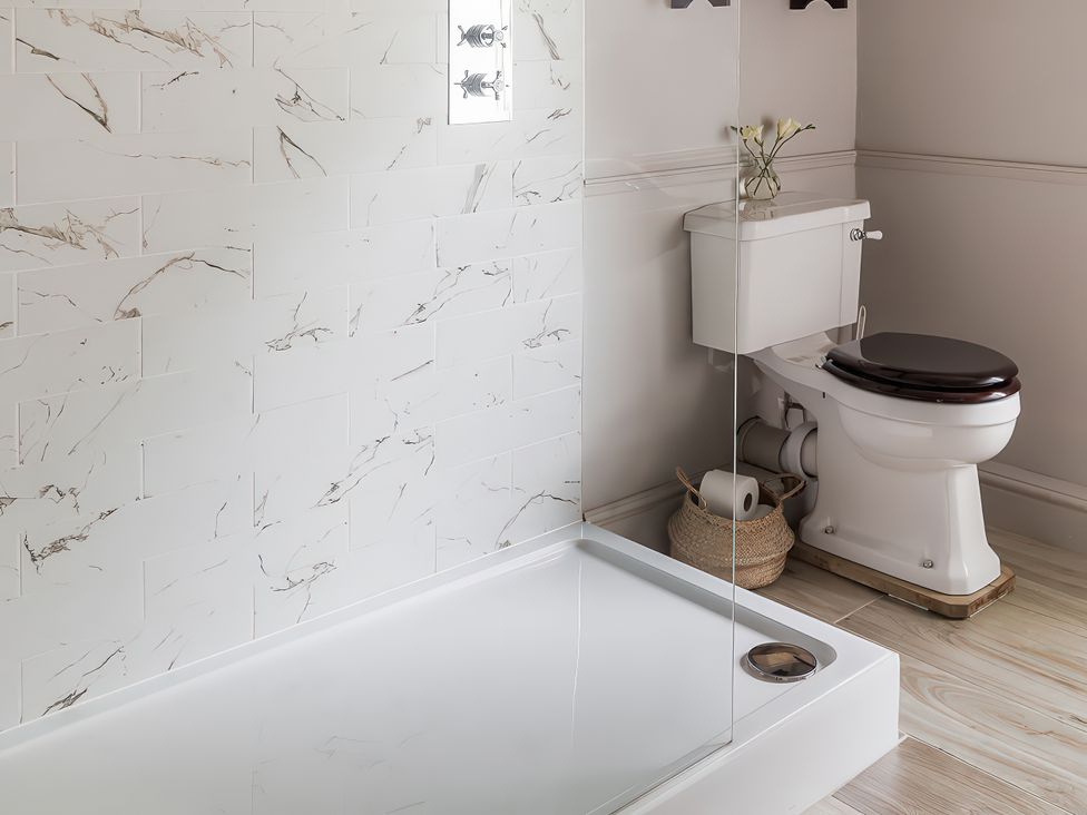 A bathroom with a shower tray and toilet at Reybridge House in Lacock