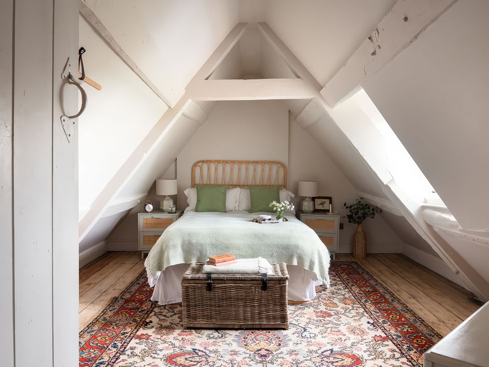 A bedroom with a bed and bedside tables at Reybridge House in Lacock