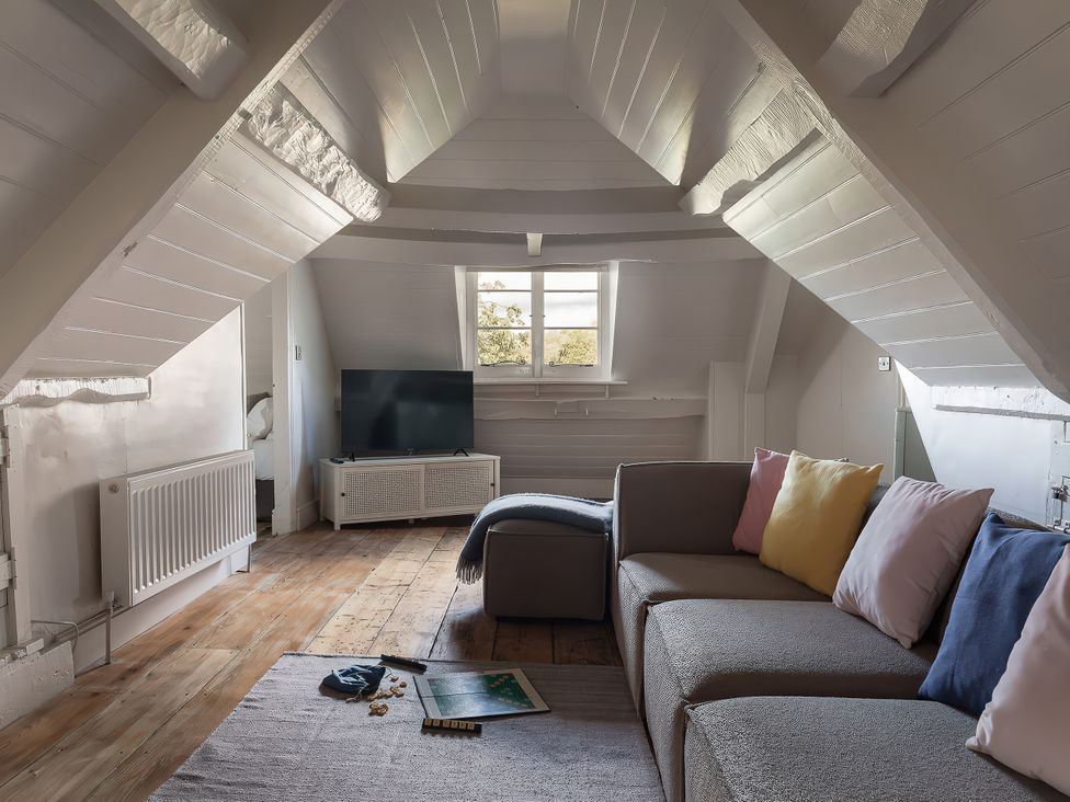 A living room with a sofa and television at Reybridge House in Lacock