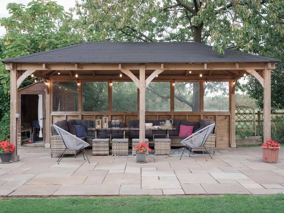 An outdoor pavilion with seating area at Reybridge House in Lacock