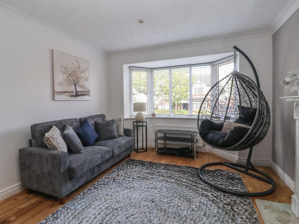 A living room with a sofa and hanging chair at 5 Harebell Close Harrogate