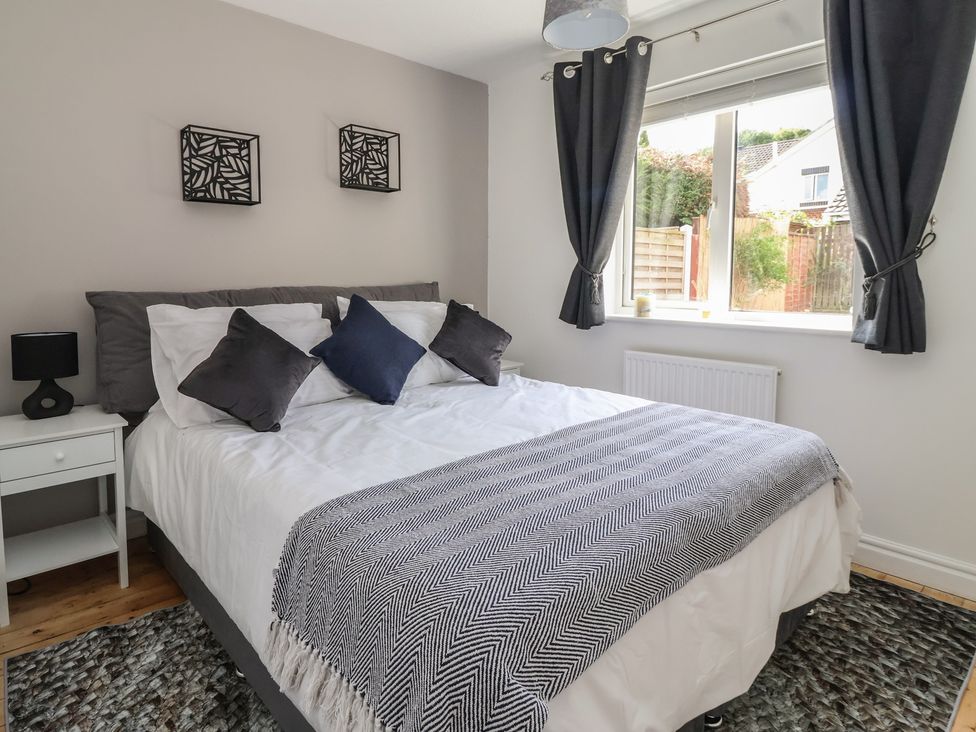 A bedroom with a bed and window at 5 Harebell Close Harrogate