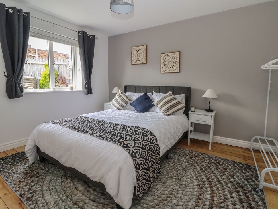 A bedroom with a bed and a bedside table at 5 Harebell Close in Harrogate
