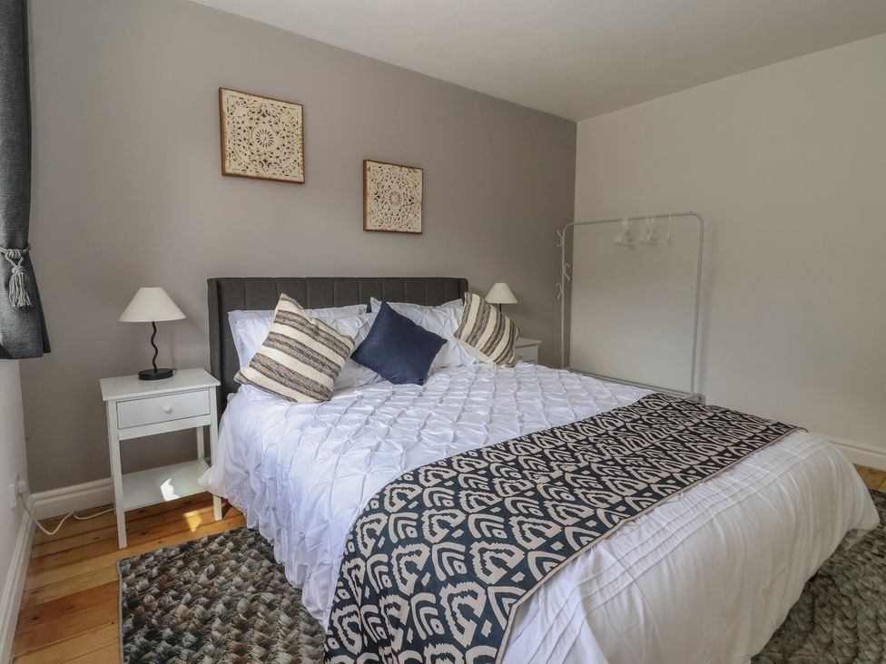A bedroom with a bed and side table at 5 Harebell Close Harrogate