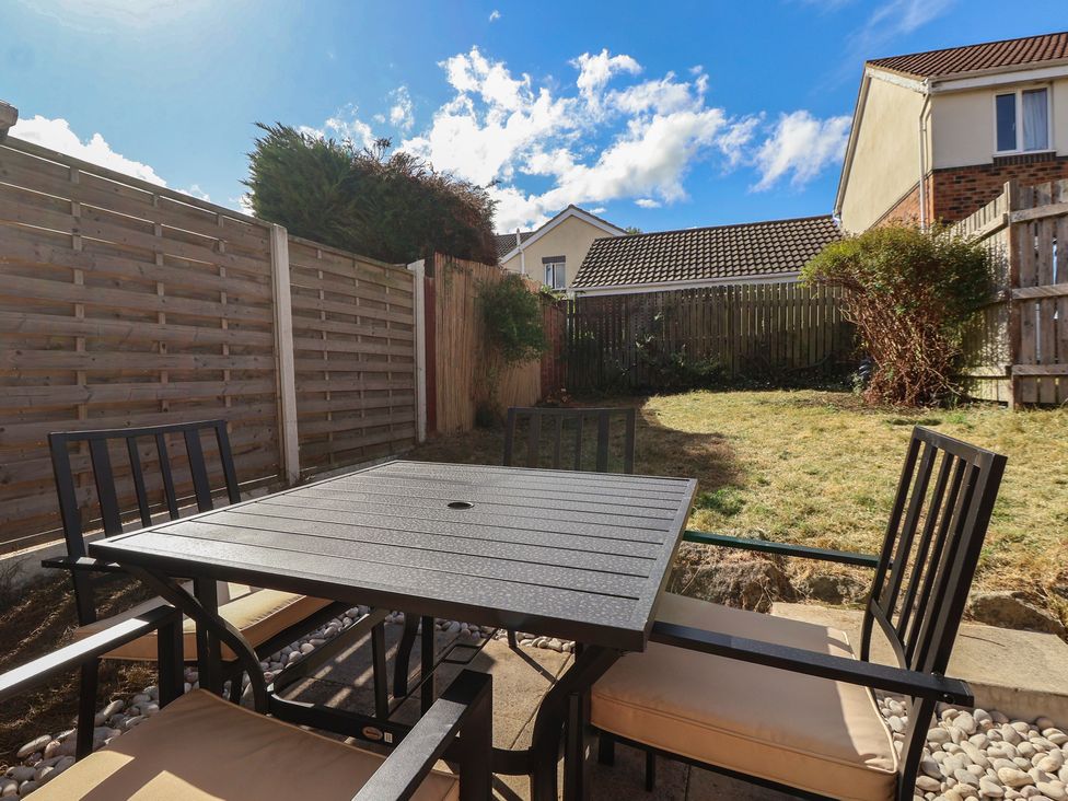 A garden with a table and chairs at 5 Harebell Close in Harrogate