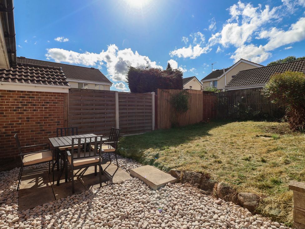 A garden with a table and chairs at 5 Harebell Close in Harrogate
