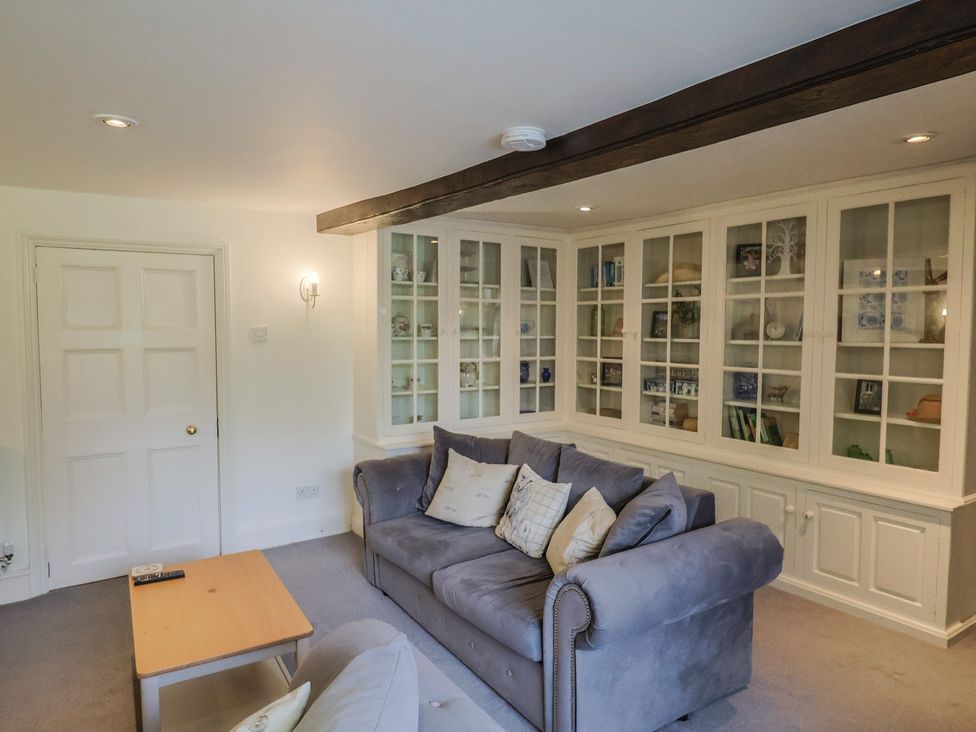 A living room with a couch and shelves at Garden View in Wellington