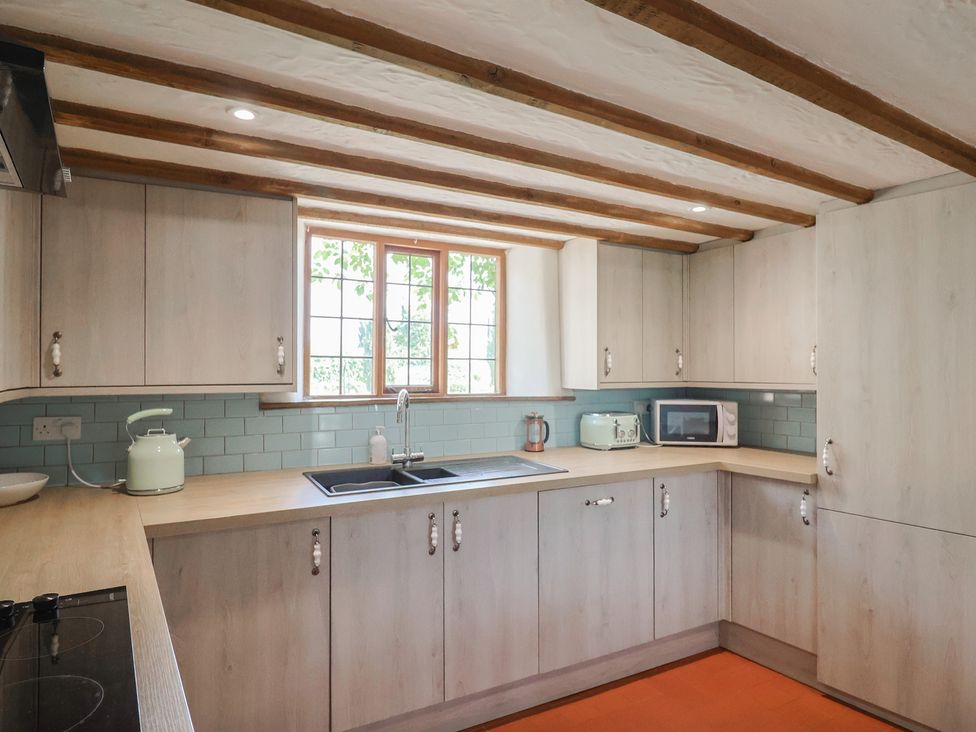 A kitchen with cabinets, a sink, and a microwave at Garden View in Wellington
