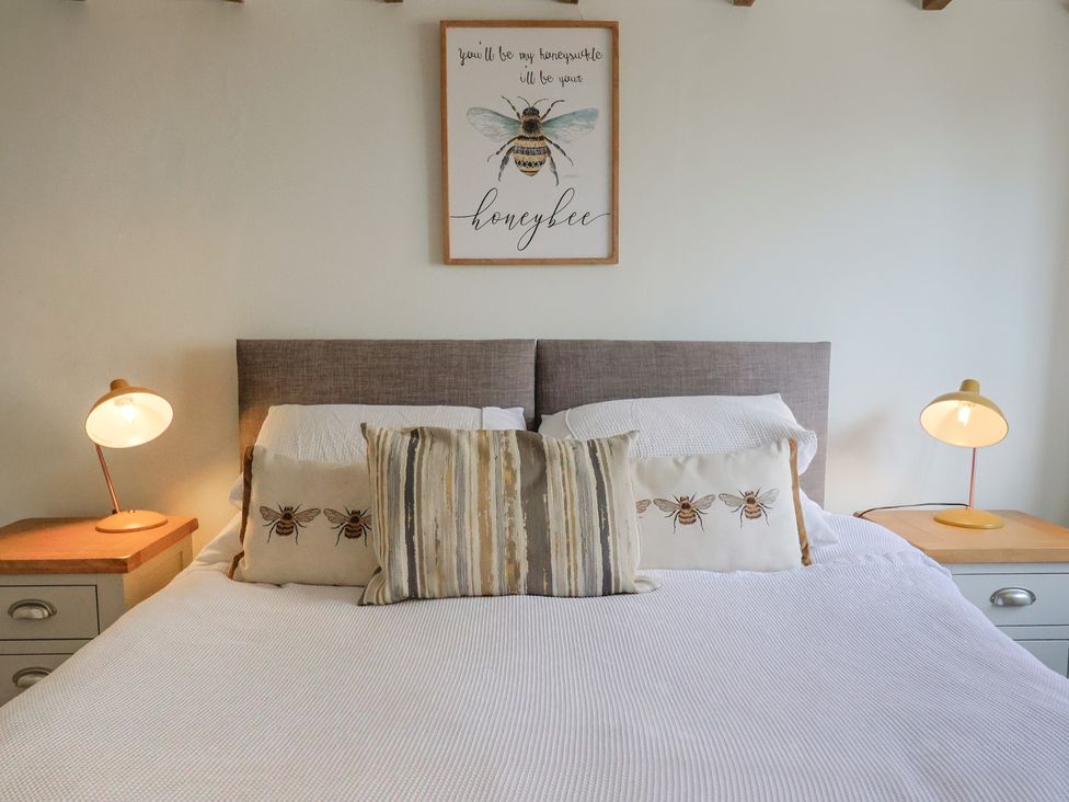 A bedroom with a bed and decorative pillows at Garden View in Wellington