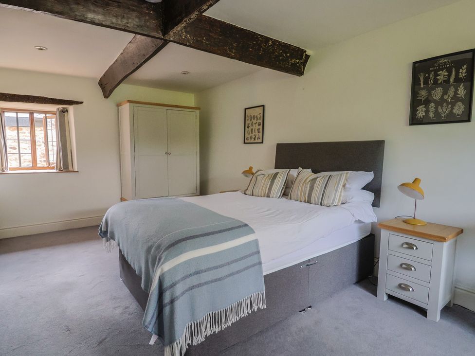 A bedroom with a bed and wardrobe at Garden View in Wellington