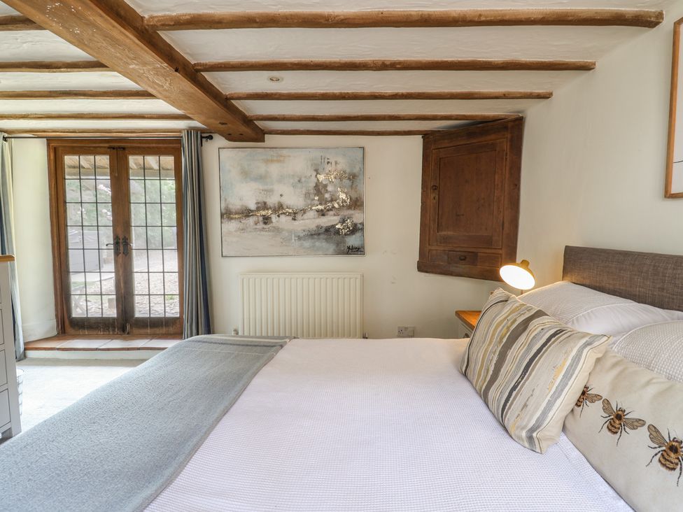 A bedroom with a bed and art on the wall at Garden View in Wellington