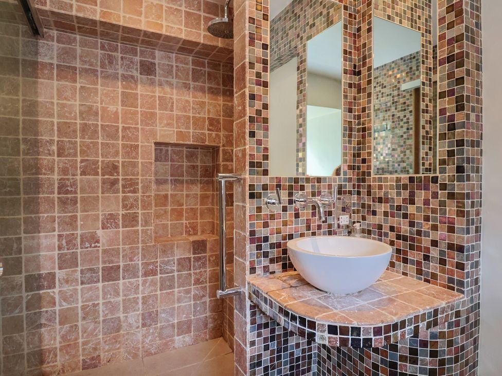 A bathroom featuring a shower and a sink at Garden View in Wellington