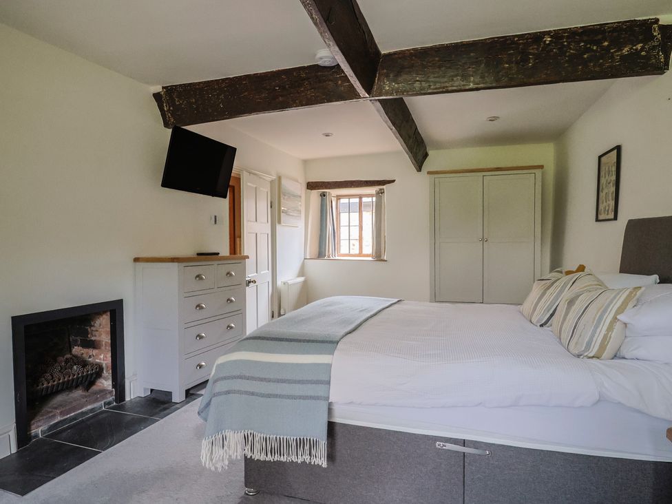 A bedroom with a bed and fireplace at Garden View in Wellington