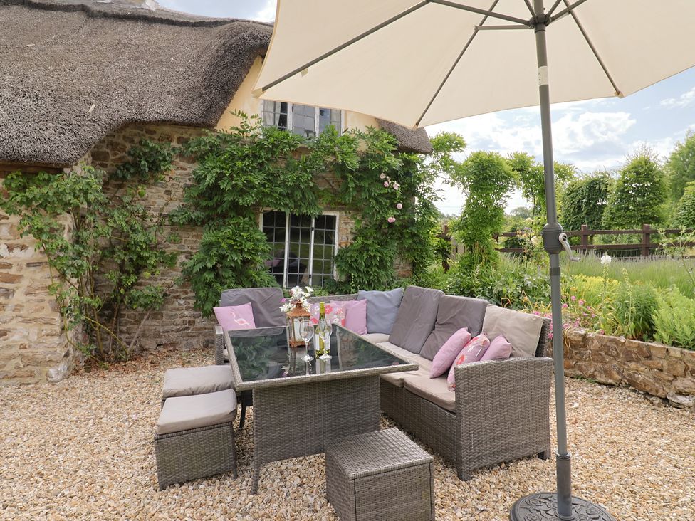 A garden with seating and a parasol at Garden View in Wellington
