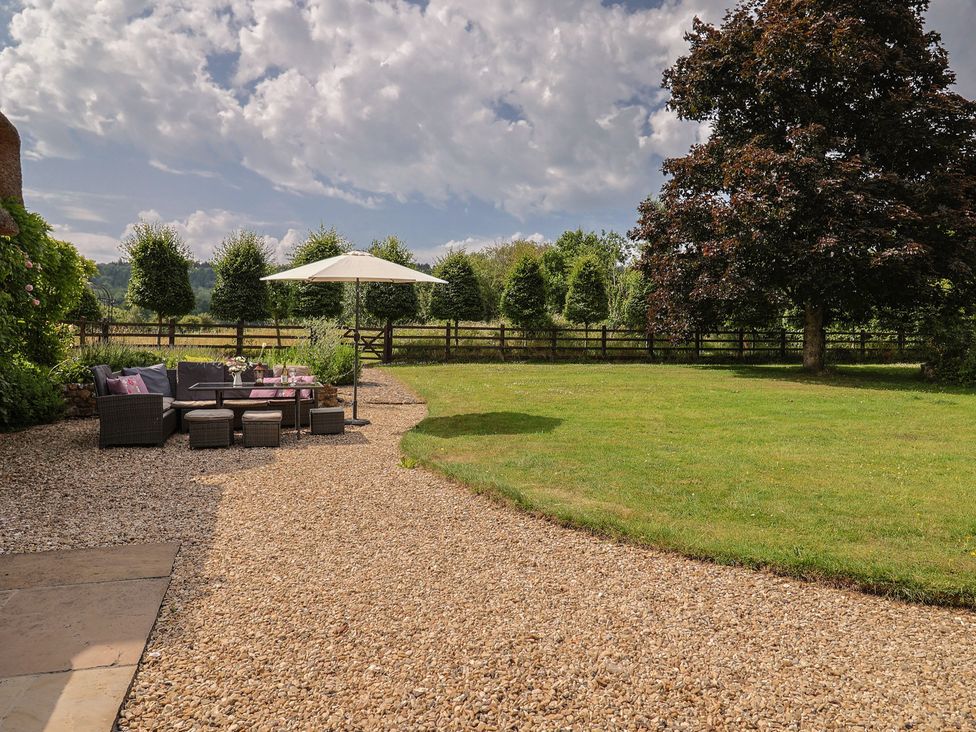 A garden with a seating area and trees at Garden View in Wellington