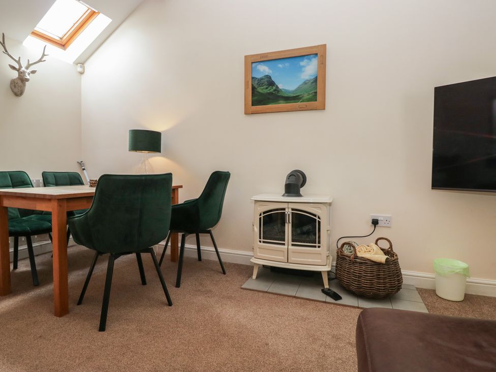 A dining room with a wooden table and chairs at Walkers Retreat in Keswick