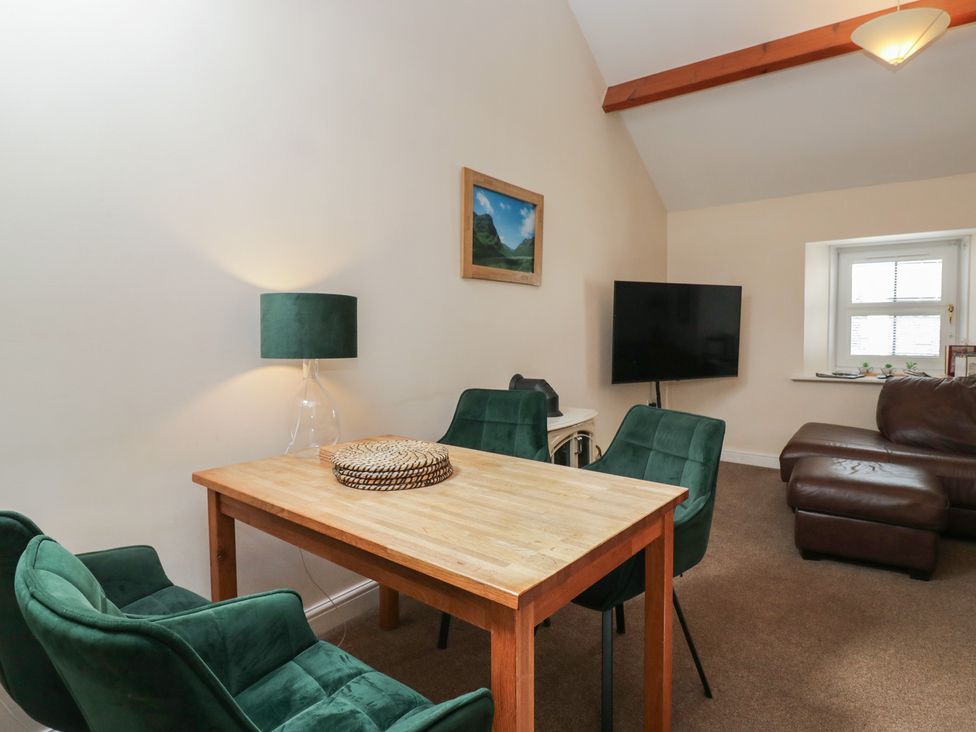 A dining room with a table and chairs at Walkers Retreat in Keswick
