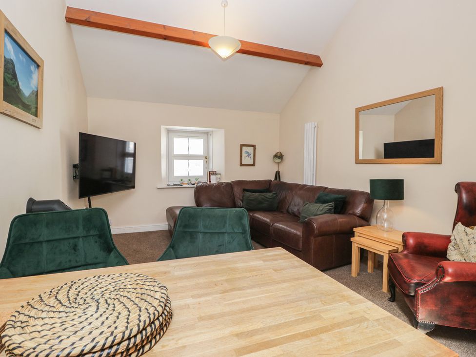 A living room with a sofa and television at Walkers Retreat in Keswick