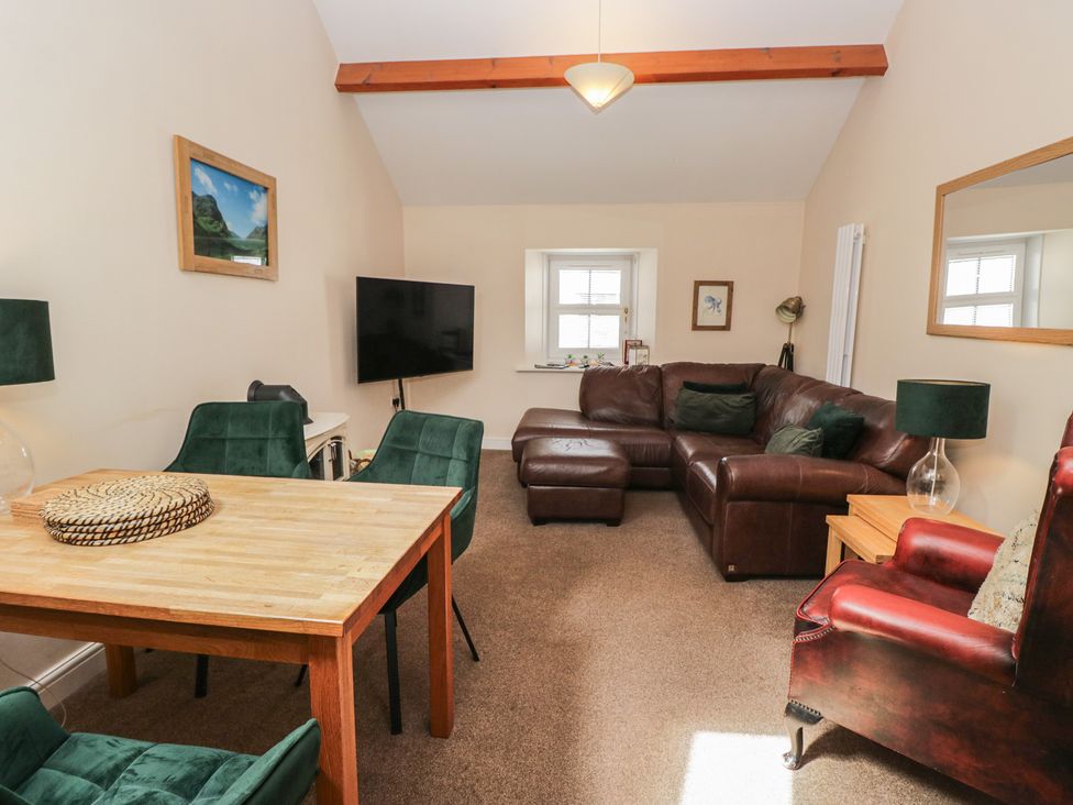 A living room with a sofa and dining table at Walkers Retreat in Keswick