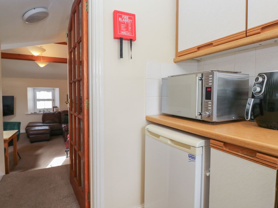 A kitchen with a microwave and refrigerator at Walkers Retreat in Keswick