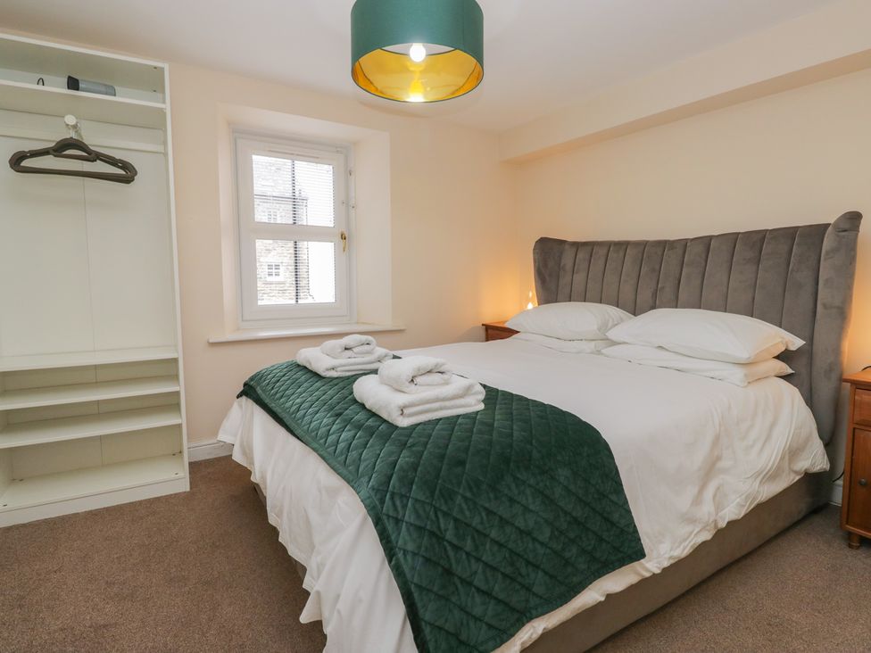 A bedroom with a bed and wardrobe at Walkers Retreat in Keswick