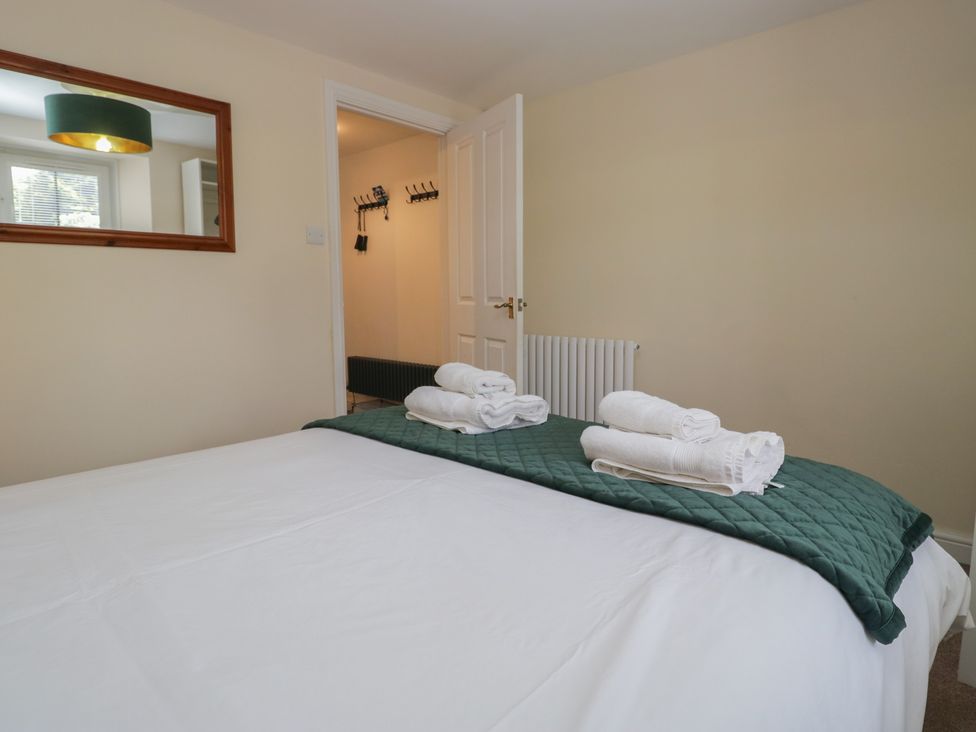 A bedroom with a bed and towels at Walkers Retreat in Keswick