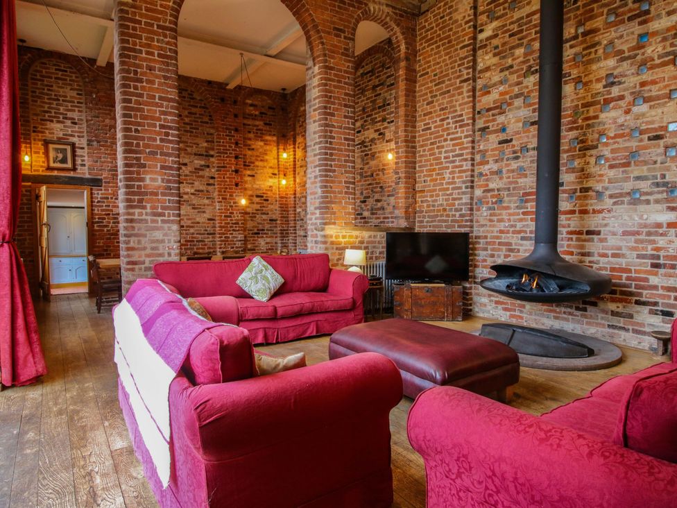 A living room with a sofa and fireplace at Windy Mundy Farm Pitchford near Shrewsbury